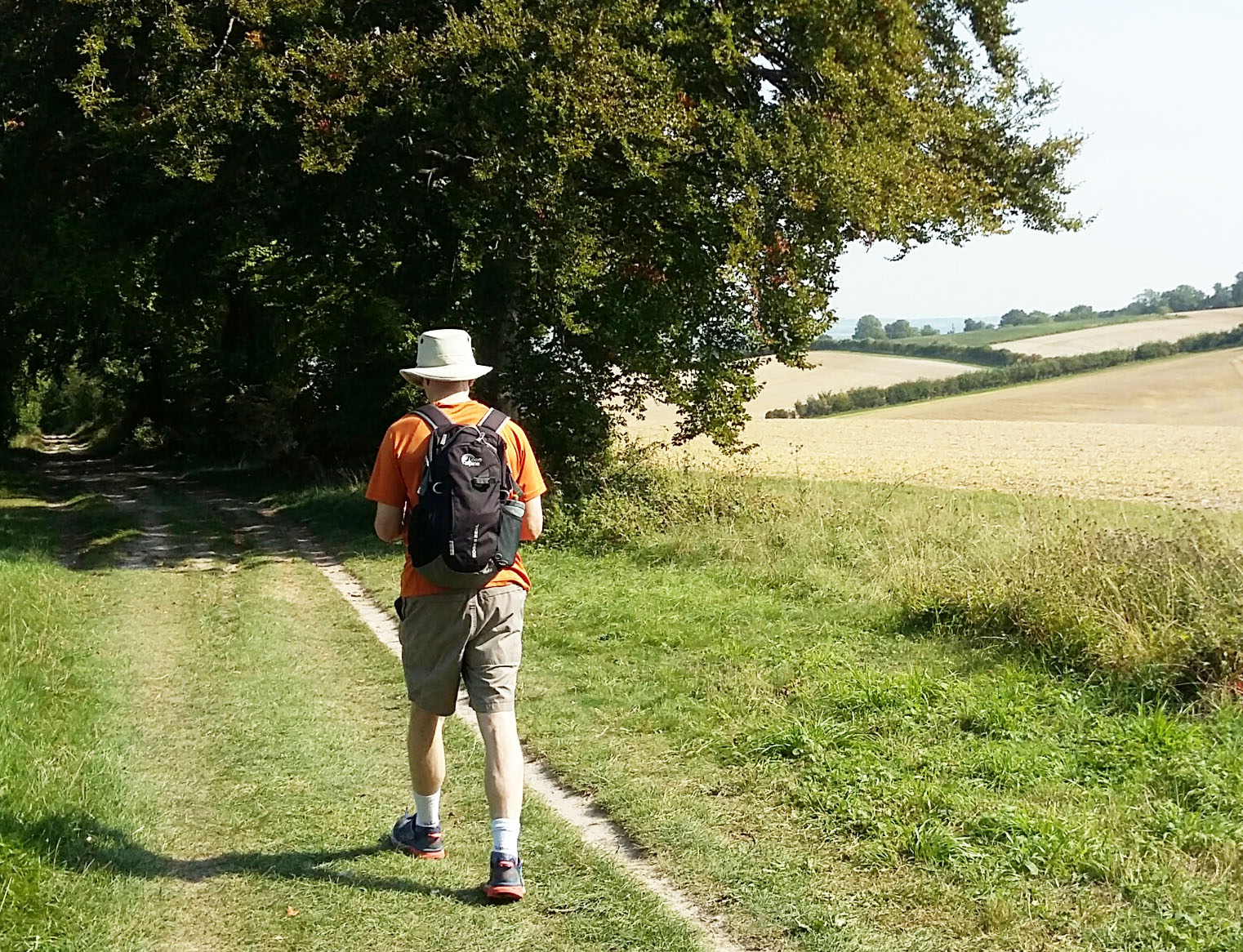 man with rucksack walking along a path