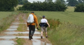 man and woman walking on a rural track in the countryside