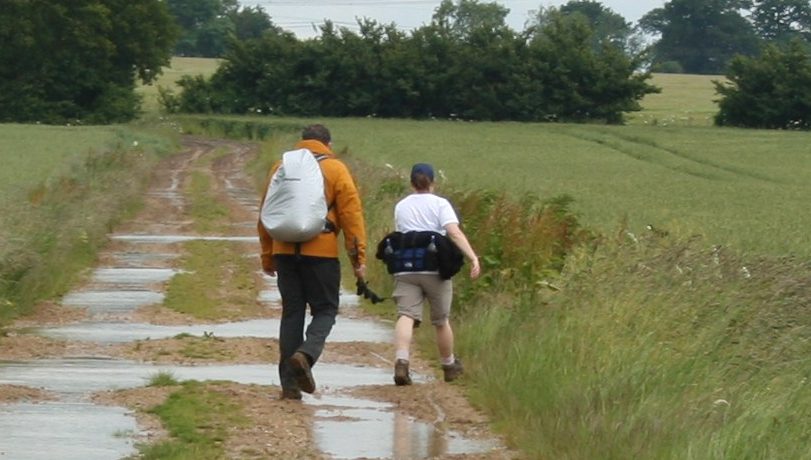 man and woman walking on a rural track in the countryside