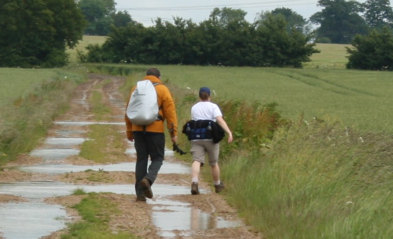 man and woman walking on a rural track in the countryside