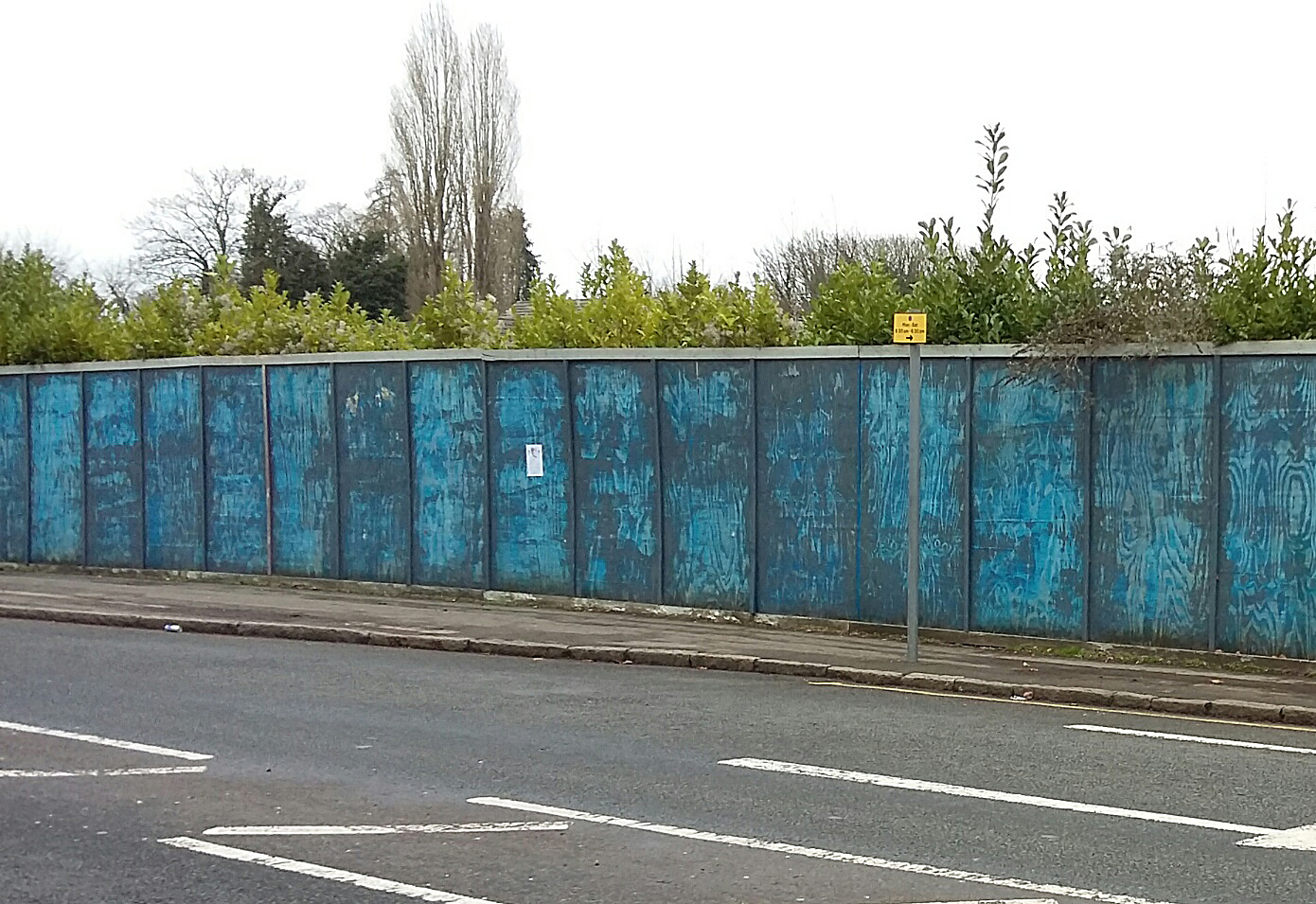 brownfield first - image shows abandoned site with hoarding