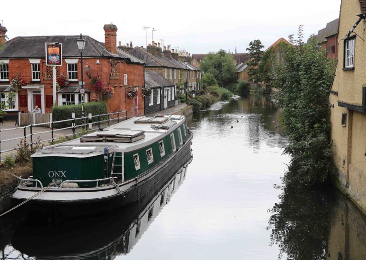 attractive view of the Lea river with a moored barge