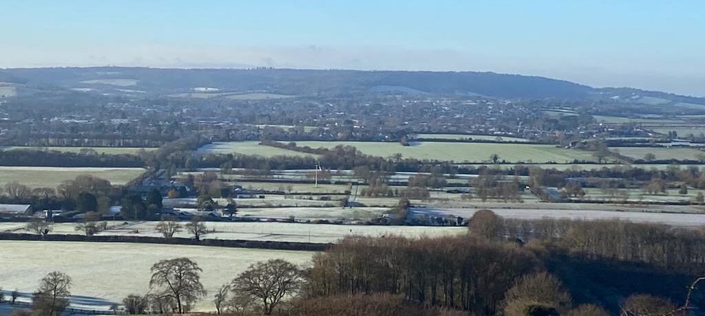 epic countryside view over the threatened site, including woodlands, green fields and hedgerows