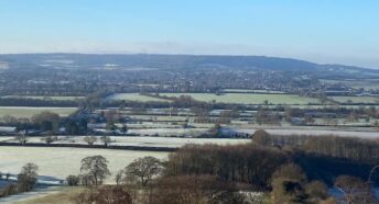 epic countryside view over the threatened site, including woodlands, green fields and hedgerows