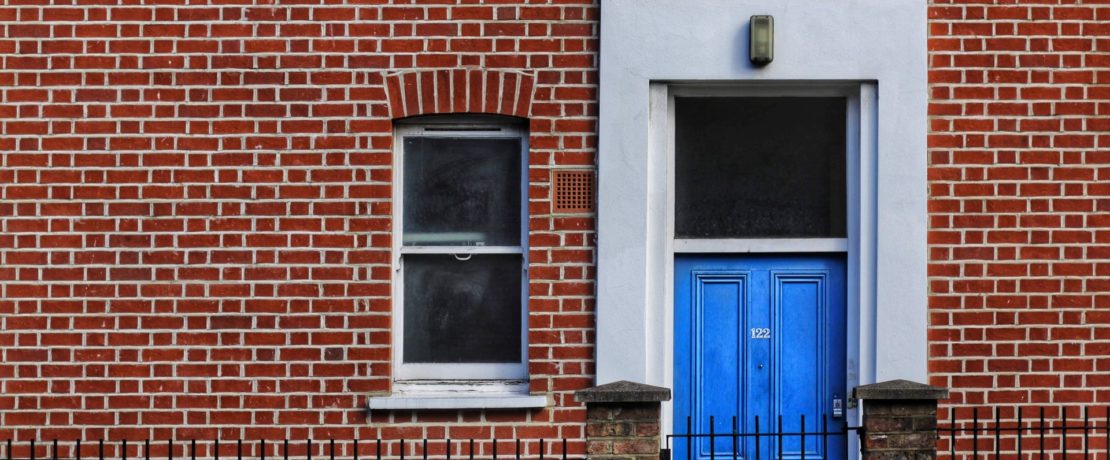 empty homes a brick townhouse with a blue front door