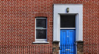 empty homes a brick townhouse with a blue front door