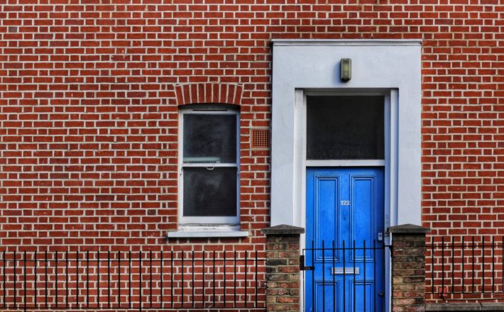 empty homes a brick townhouse with a blue front door