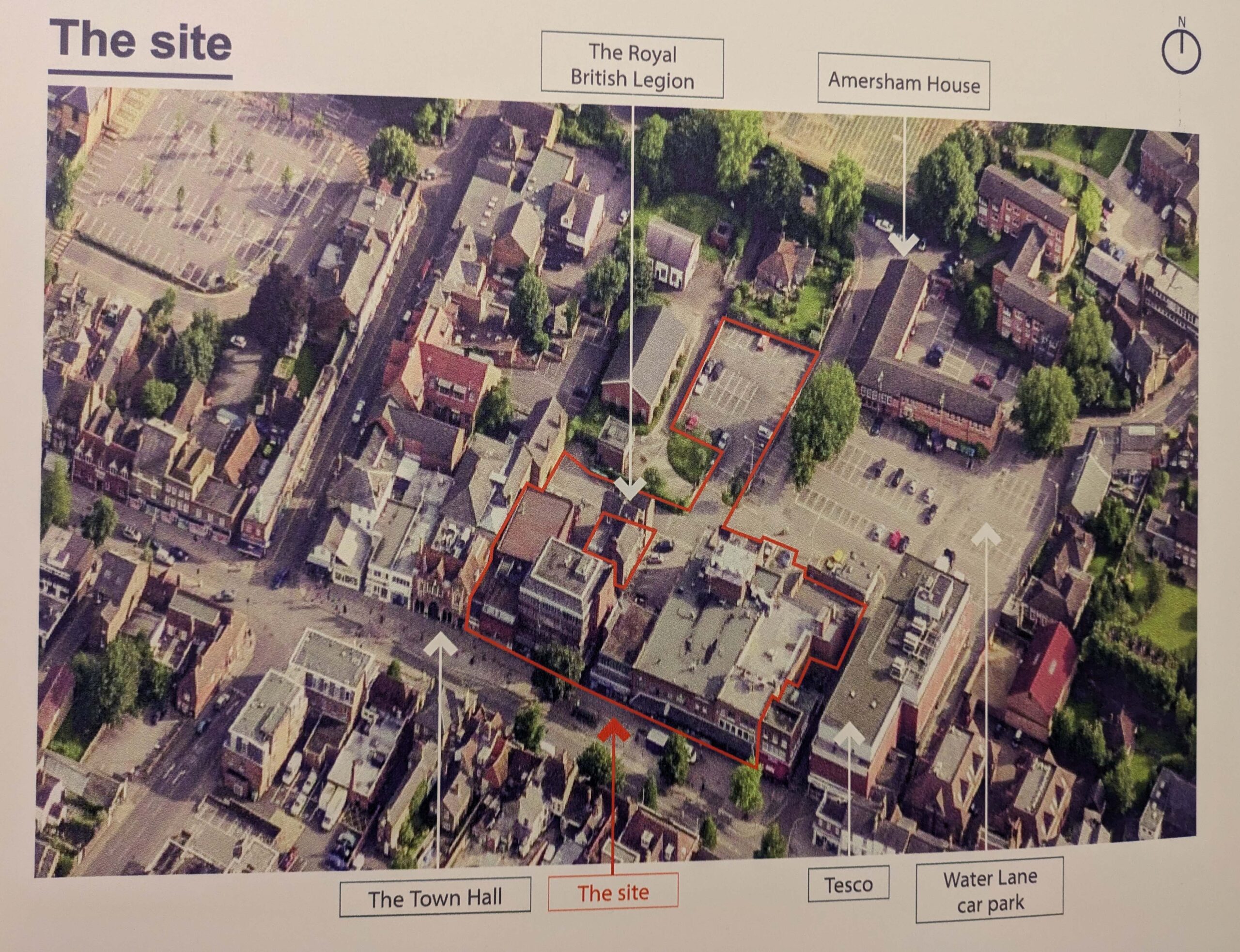 aerial view of town centre site with buildings and car park