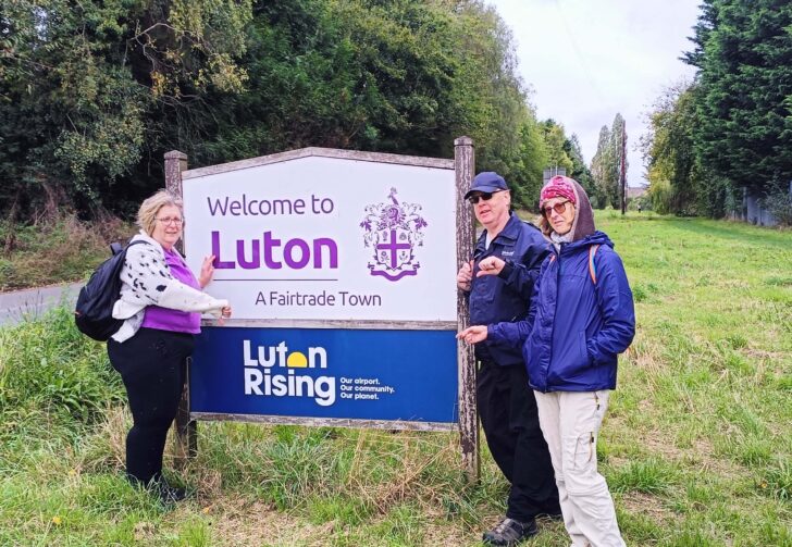 airport expansion: walkers and luton airport signpost