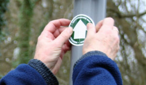 person installing a new Hertfordshire Way waymark